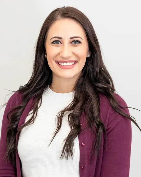 Nadia, smiling, at the office